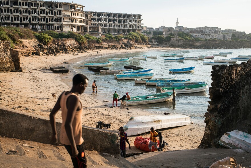 Fishing boats gather at dawn in the old port in Mogadishu, the Somali capital, in front of destroyed Aruba Hotel. Somali fishermen-turned-pirates have made the waters off the Horn of Africa one of the most treacherous places in the world for international shipping vessels.