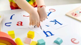 Un niño juega con letras.