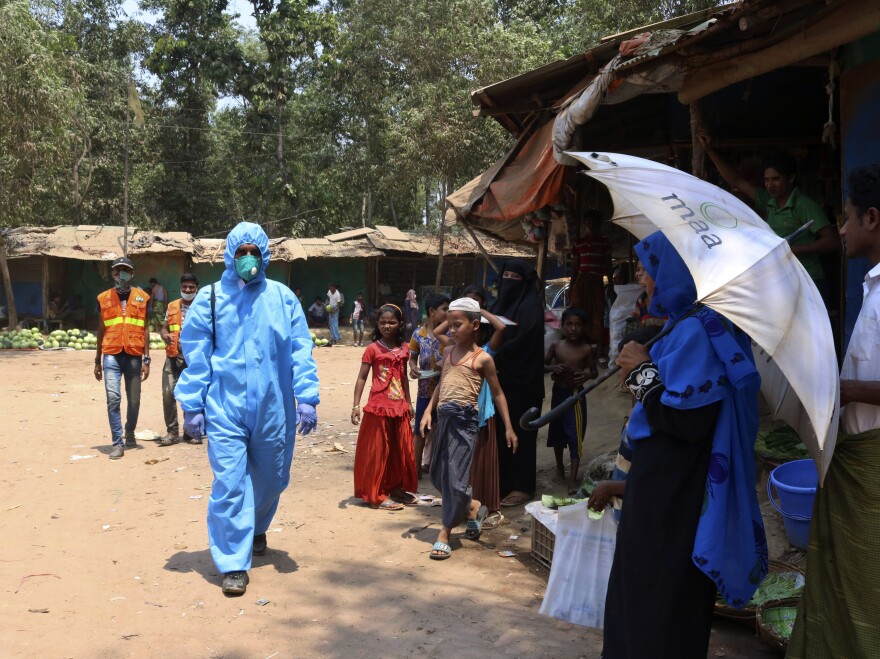 A health worker wearing personal protective equipment in the Kutupalong Rohingya refugee camp in Cox's Bazar, Bangladesh, last month. On Thursday, Bangladesh reported the area's first confirmed coronavirus infections.