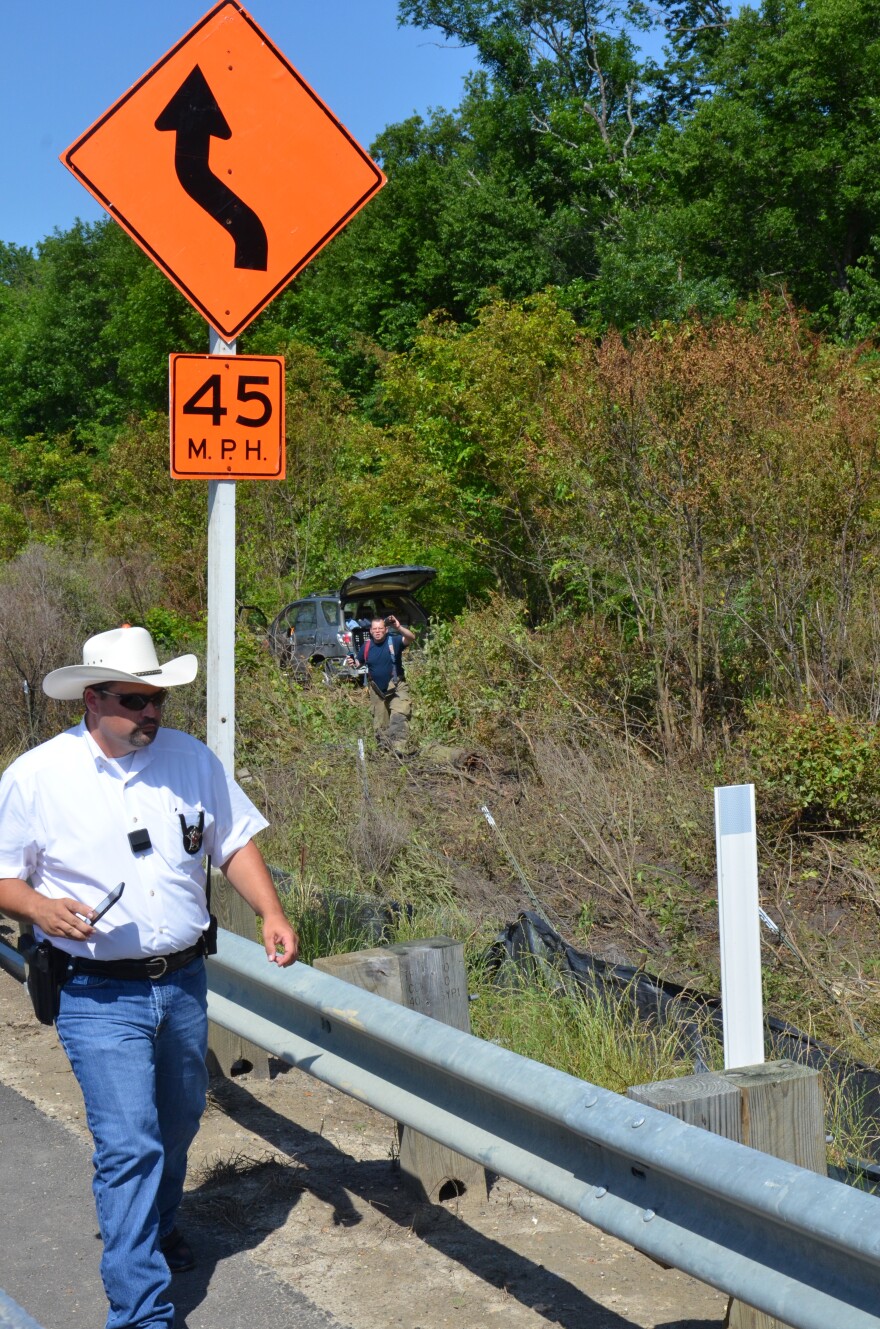 Delta County Deputy Marshall Lynch and Cooper Volunteer Fire Fighter Lewis Taylor examine the accident scene at John’s Creek. 