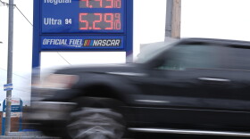 A vehicle passes a gasoline price board at a filling station in Philadelphia, Friday, March 27, 2026.