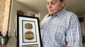 Mike Fratello, in his suburban Cleveland home, shows a plaque honoring his father Vincent Fratello, who was a Gold Gloves boxer who later turned pro. 