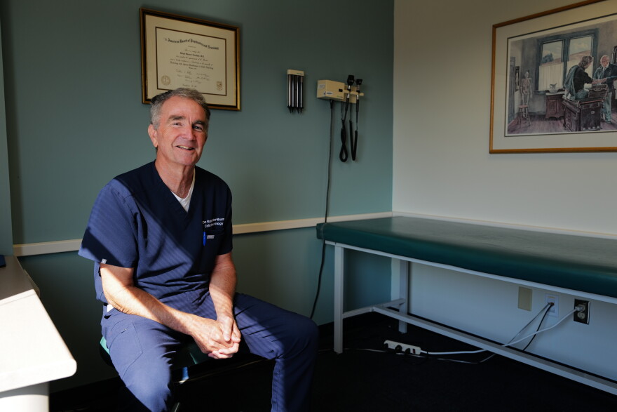 Ralph Northam sits in an exam room where he spends much of his time treating patients.