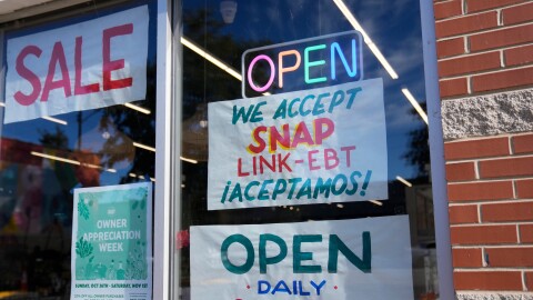 Signage showing that the USDA Supplemental Nutrition Assistance Program (SNAP) is accepted is displayed at Wild Onion Market, Monday, Oct. 27, 2025, in Chicago. (AP Photo/Erin Hooley)
