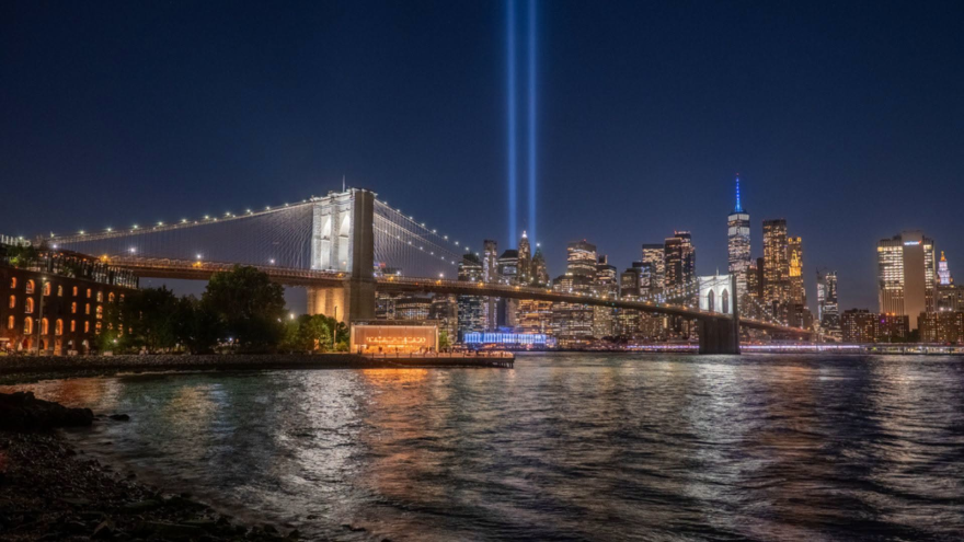 The "Tribute in Light" behind New York's Brooklyn Bridge, honors the original 110-story Twin Towers. A new 1,776-foot-tall One World Trade Center opened near the WTC site in 2014.