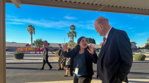 Principal Analisa Angulo animatedly shares the keys to Desert View Academy's success with Horne.