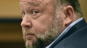 FILE - Infowars founder Alex Jones appears in court to testify during the Sandy Hook defamation damages trial at Connecticut Superior Court, Sept. 22, 2022, in Waterbury, Conn. Relatives of victims of the Sandy Hook Elementary School shooting are asking a bankruptcy judge to liquidate Jones' media company including Infowars instead of allowing him to reorganize his business, as they seek to collect on $1.5 billion in lawsuit verdicts against him. (Tyler Sizemore/Hearst Connecticut Media via AP, Pool, File)