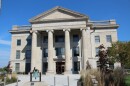 An image of the front of the Boone County Courthouse building. There are sandstone columns at the front. 