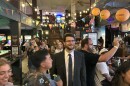 William Lawrence looking up ahead in a crowded bar