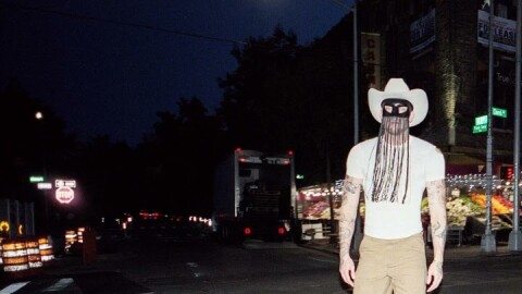 Orville Peck walking down the street 