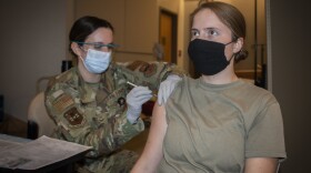 Air Force Senior Airman Kasey Ginn, medical technician, administers the COVID-19 vaccine to Army Capt. Christine Kasprisin, physical therapist, at Brooke Army Medical Center, Fort Sam Houston, Texas, Jan. 26, 2021. The San Antonio Military Health System is starting the next phase of the Department of Defense’s COVID-19 vaccine rollout -- expanding the scope of who is eligible to get vaccinated against the virus.