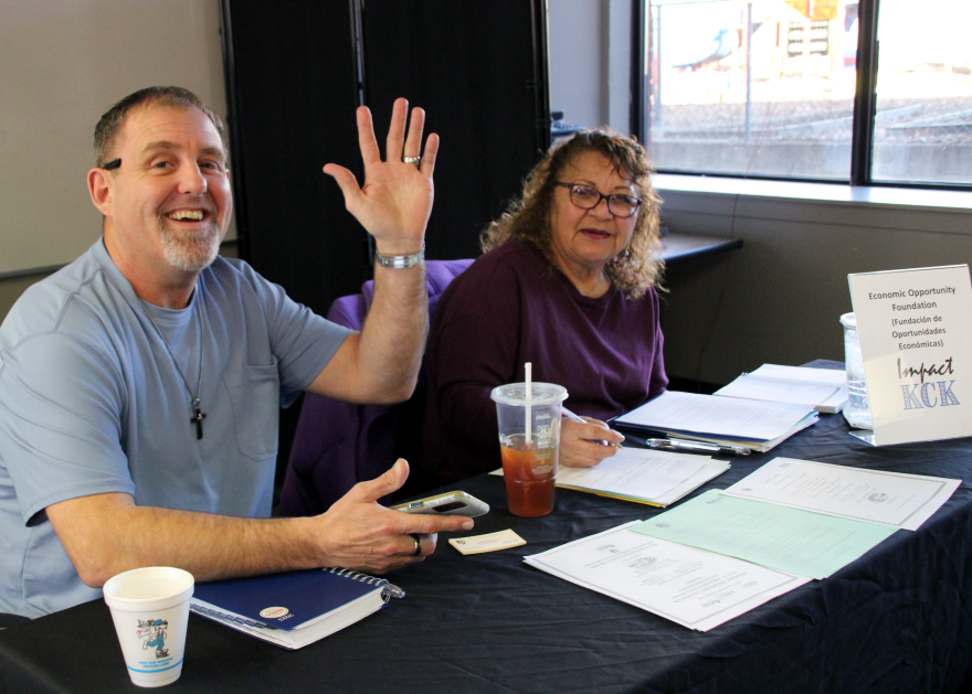 Terry DeMoss and Regina Casares sit at a table at Impact Wednesday, waiting to connect families with social services.