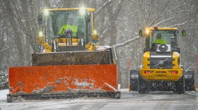 Snow plows clear a road in Mansfield, Ct., as schools closed and forecasts called for up to four inches of snow across the region.