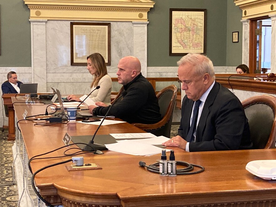 Ways and Means Committee members sit shoulder to shoulder at meetings.