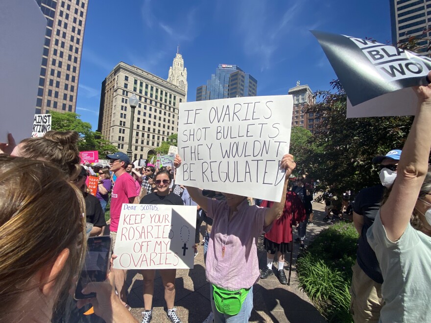  Protestors carry homemade signs at abortions rights rally at the Ohio Statehouse on May 14, 2022 