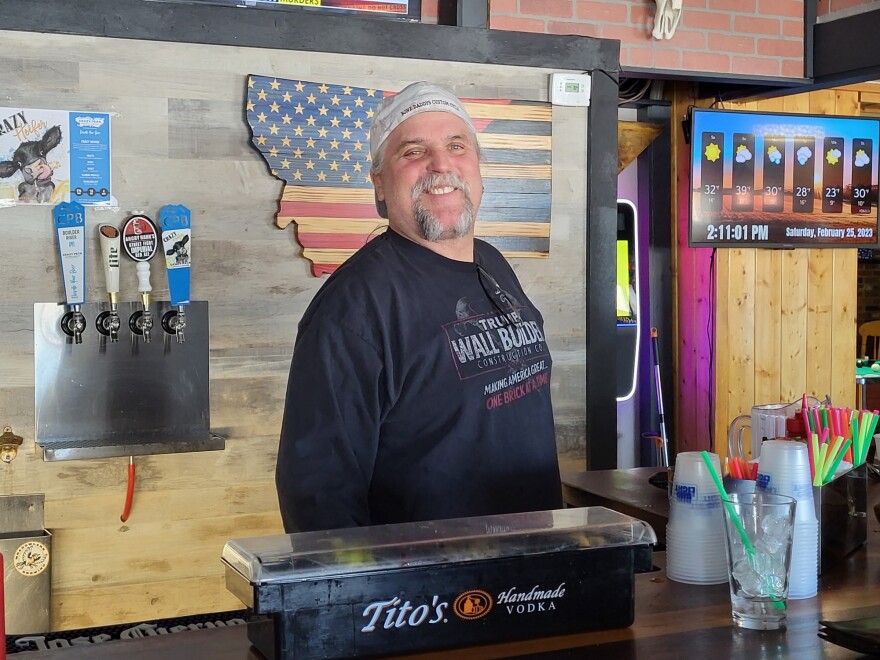 Manager Jimmy Howard stands behind the bar at the Lost Village Roadhouse Saloon in Roberts, Montana.