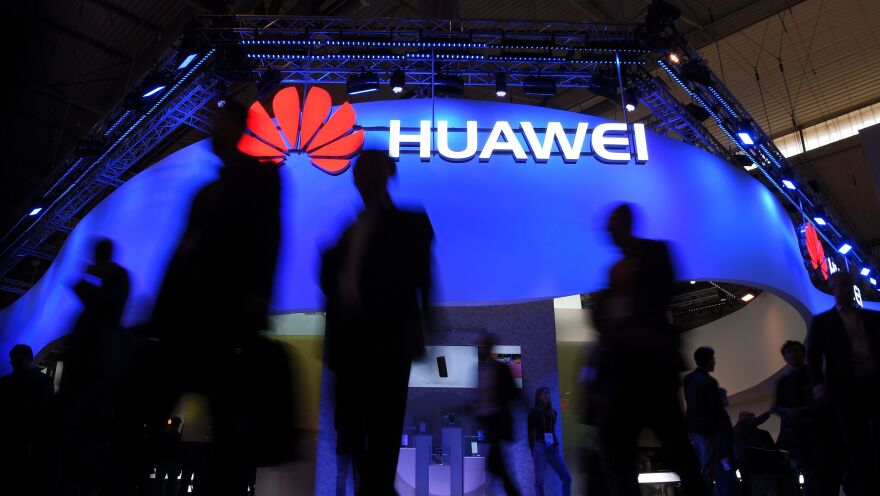 Visitors pass a Huawei marquee in Barcelona during the Mobile World Congress last year. The daughter of the Chinese telecommunications giant's founder was arrested Saturday in Canada on U.S. request, in a move that threatens to inflame U.S.-China trade tensions.