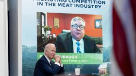 President Joe Biden attends a virtual meeting with family and independent farmers and ranchers including Scott Blubaugh, President, Oklahoma Farmers Union, visible on the monitor, at the South Court Auditorium in the Eisenhower Executive Office Building on the White House Campus in Washington, Monday, Jan. 3, 2022, to discuss work to boost competition and reduce prices in the meat-processing industry. (AP Photo/Andrew Harnik)