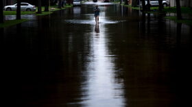 A woman walks down a flooded road during the aftermath of Hurricane Harvey on Aug. 30, 2017 in Houston, Texas. (Brendan Smialowski/AFP/Getty Images)
