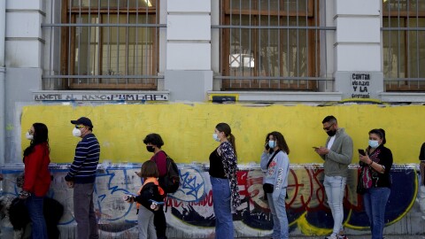 People line up to vote in a plebiscite on a new draft of the Constitution in Santiago, Chile, Sunday, Sept. 4, 2022.