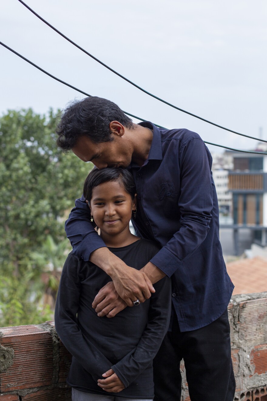 Sayyid Ali Hussaini kisses his 9-year-old daughter Elisa. "Those things I witnessed in my childhood, I don't want them for my girl," he says. "For this I'm here. To have a peaceful life, to continue life in a peaceful way."