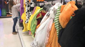 A customer looks through kids Halloween costumes at a Target department store on Tuesday, Oct. 2, 2018, in Aventura, Fla. (Brynn Anderson/AP)