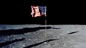 The U.S. flag stands alone on the surface of the moon.