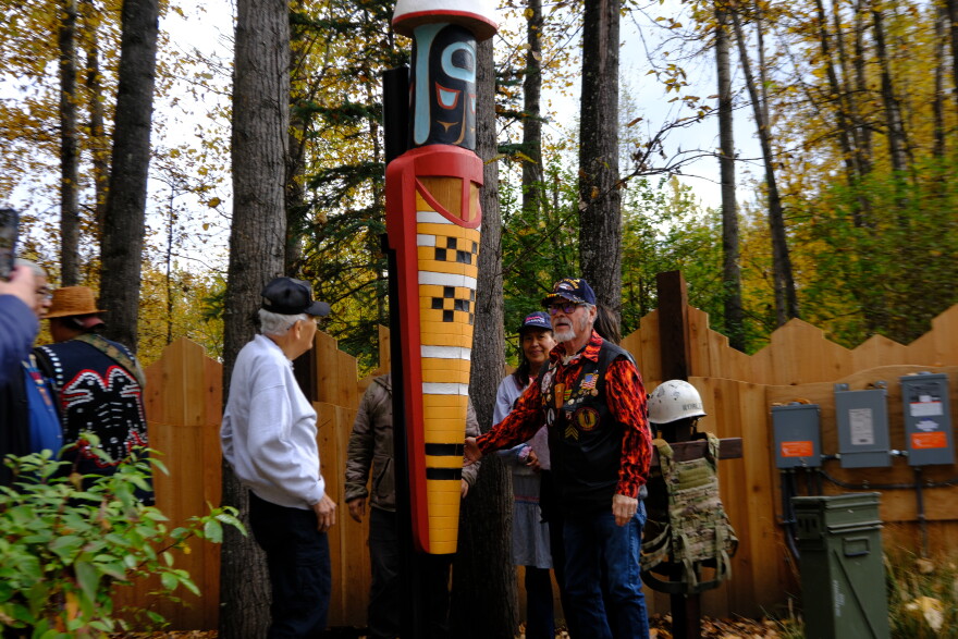 The chief of the Valdez Native Tribe Bill Smith (right) and other veterans unveil a new monument at the Alaska Native Heritage Center’s Ngíisdla Garden on Sunday, Sept. 27.