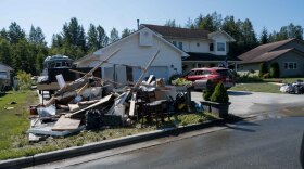 Juneau residents pile up belongings damaged by a glacial outburst flood.