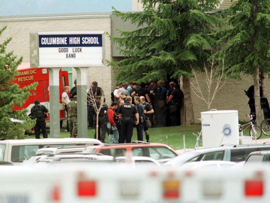 Police gathered at the east entrance of Columbine High School in Littleton, Colo., on April 20, 1999, after two teen students went on a shooting rampage before turning the weapons on themselves.