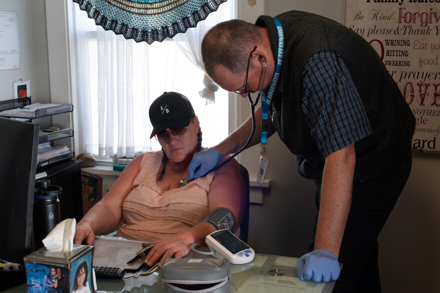 Dr. Robey checks on a patient at a day shelter for women who are homeless in Everett.