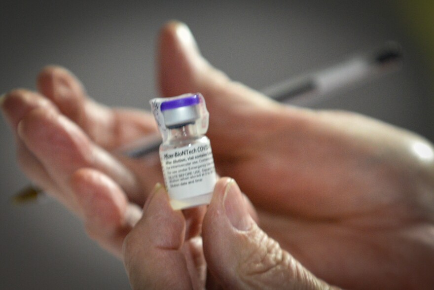  A technician displays a vial of the Pfizer BioNTech COVID-19 vaccine.