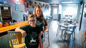 Ashley Driemeyer, co-owner of The Fainting Goat, and her son, Dalton, pose in the main bar and seating area of their Breese location. Driemeyer is frustrated with the state restrictions and like several restaurant and bar owners in the region, she is defying the orders and opening indoor areas to service. 