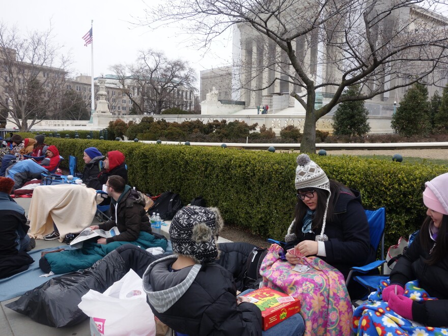 More than two dozen people bundled up to camp out before the U.S. Supreme Court for a seat to watch oral arguments in a same-sex marriage case on Tuesday.