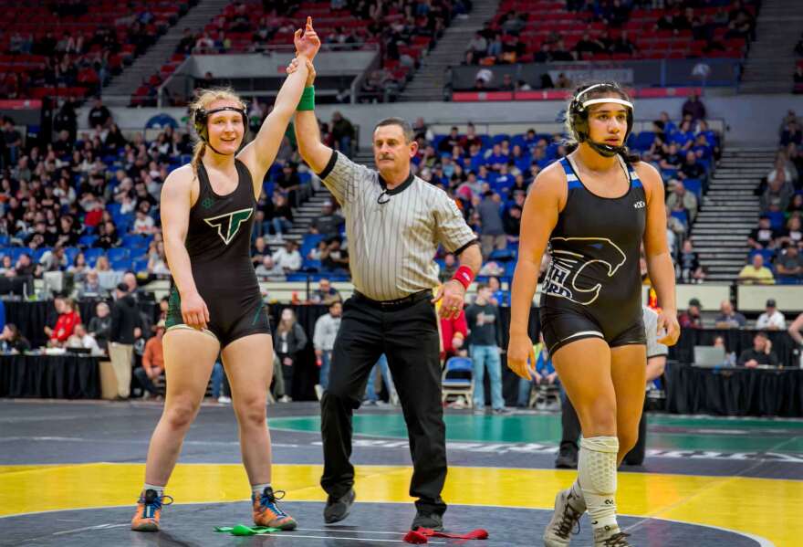 Natalie Wilhoit, left, of Tigard High School is declared the winner in her semi-final bout against Leilarose Calva of South Medford High School.