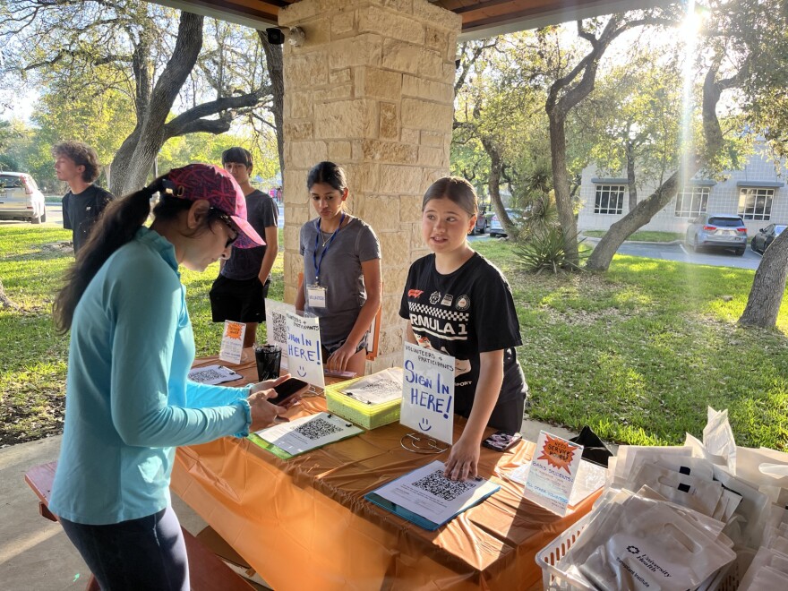 Student volunteers sign in race participants