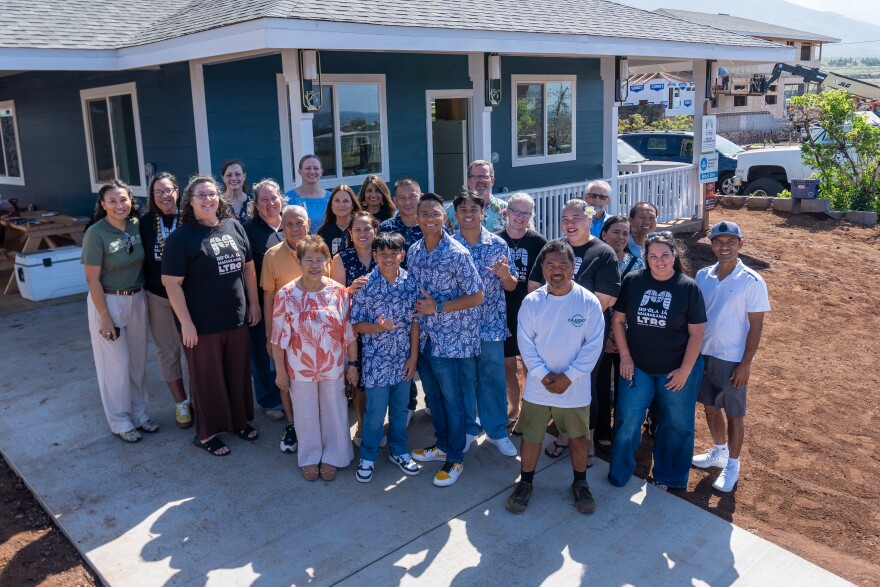 The Yadao family (center) at their rebuilt Lahaina home, with Mennonite Disaster Services volunteers and Hoʻōla iā Mauiakama Disaster Long Term Recovery Group staff that helped them rebuild.