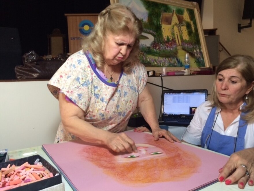 Valdelice Da Silva Dias Salum, 77, says she channels the spirits of famous painters to create her artwork.