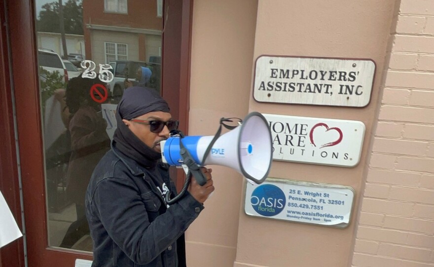 Demonstrators rally outside OASIS offices