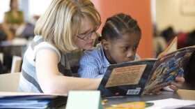A teacher reads to her student. (UNDATED PHOTO).