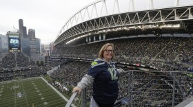 FILE - Seattle Seahawks owner Jody Allen stands on a balcony at CenturyLink Field after she raised the 12th man flag before the team's NFL football game against the Los Angeles Rams, Thursday, Oct. 3, 2019, in Seattle.