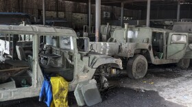 Damaged military vehicles and a Ukrainian flag are seen at the partly destroyed steel plant in an area controlled by Russian-backed separatist forces in Mariupol on Monday.