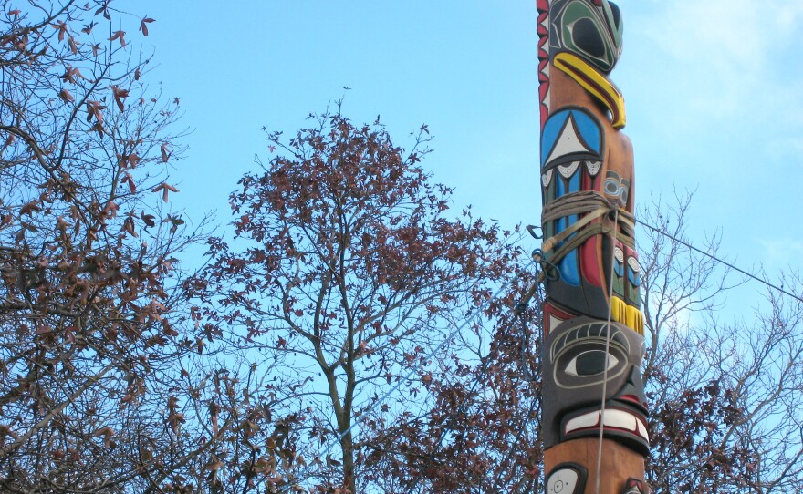 A totem honoring slain First Nations woodcarver John T. Williams was raised at the Seattle Center on Sunday.