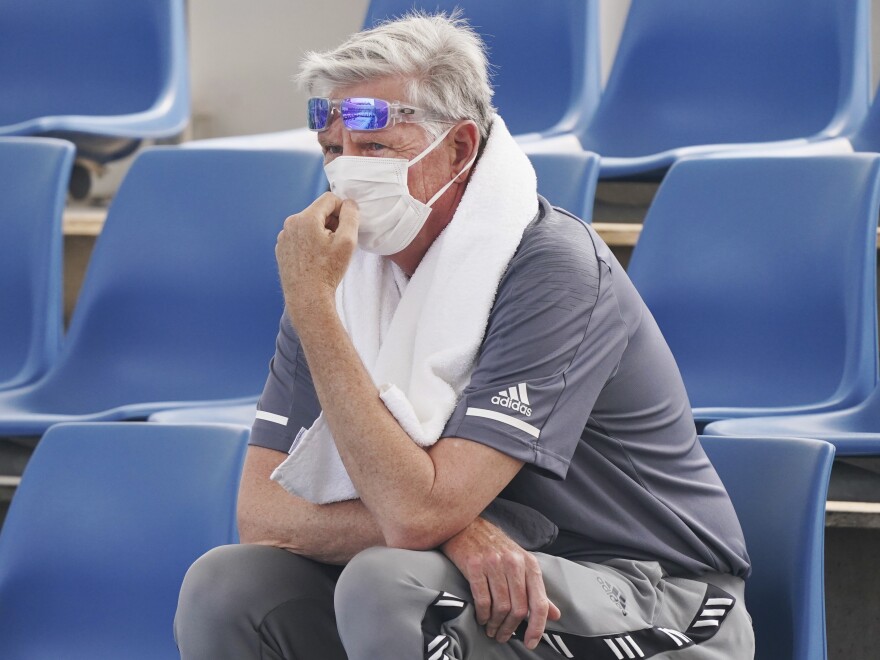 A spectator wears a mask to cope with the smog during an Australian Open practice session at Melbourne Park. Poor air quality caused practice sessions to be suspended on Tuesday.