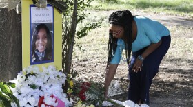 In this July 21, 2015 file photo, Jeanette Williams places a bouquet of roses at a memorial for Sandra Bland near Prairie View A&M University, in Prairie View, Texas.