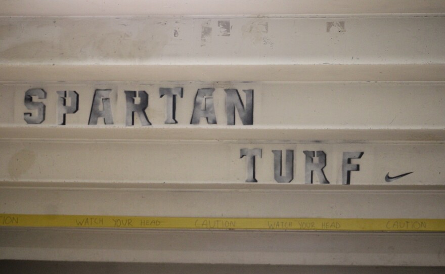 - The football sideline at Spartan Stadium Before Michigan State’s Football game against Penn State on Nov. 14, 2025. - McDougal Striping the field before Michigan State’s Football game against Penn State on Nov. 14, 2025. - NCAA Women's Soccer Tournament Banner at the Old College Field Gates on Nov. 14, 2025. - The soccer field at DeMartin Stadium on Nov. 14, 2025, the day before the first round of the NCAA Women’s Soccer Tournament. - Michigan State athletic turf workers performing final checks on the field at DeMartin Stadium ahead of the first round of the NCAA Women’s Soccer Tournament, Nov. 14, 2025 - Michigan State Athletic Turf workers inspecting the field ahead of the first round of the NCAA Women’s Soccer Tournament, Nov. 14, 2025 - Spartan Turf logo displayed under the bleachers at Spartan Stadium, Nov. 14, 2025