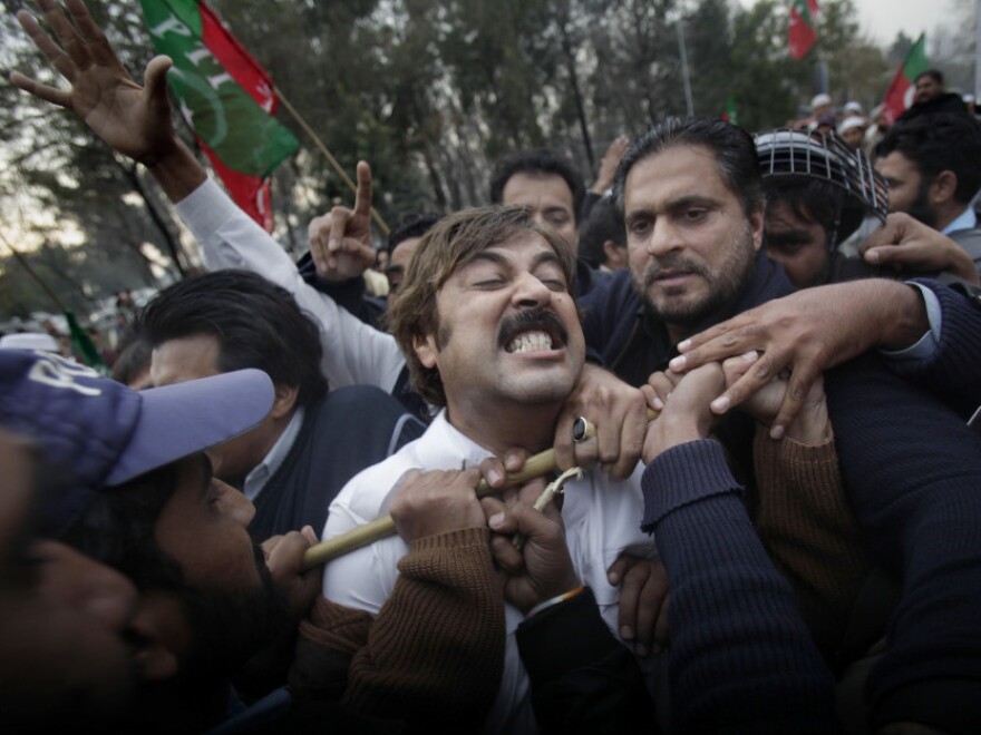 Pakistani demonstrators scuffle with police blocking them from reaching the U.S. embassy during a protest in Lahore.