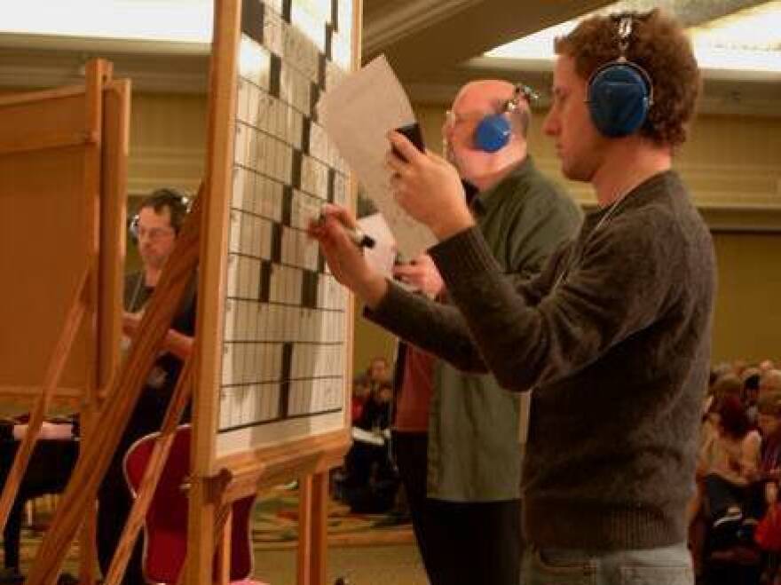 Challengers work to solve puzzles in the 2011 American Crossword Puzzle tournament. This year, a computer program named "Dr. Fill" will be allowed to unofficially compete.