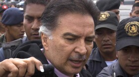 Former Guatemalan President Alfonso Portillo speaks with journalists in Guatemala City before boarding a plane for the U.S. on Friday.