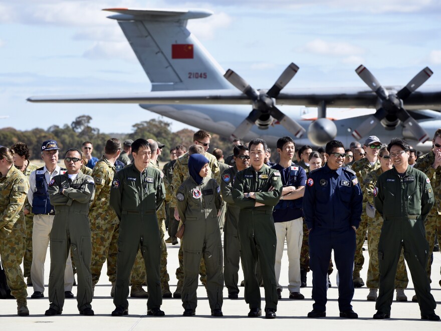 International air crews involved in the search for the missing Malaysia Airlines plane gathered Tuesday on the tarmac at the Royal Australian Air Force Pierce Base in Bullsbrook, near Perth.